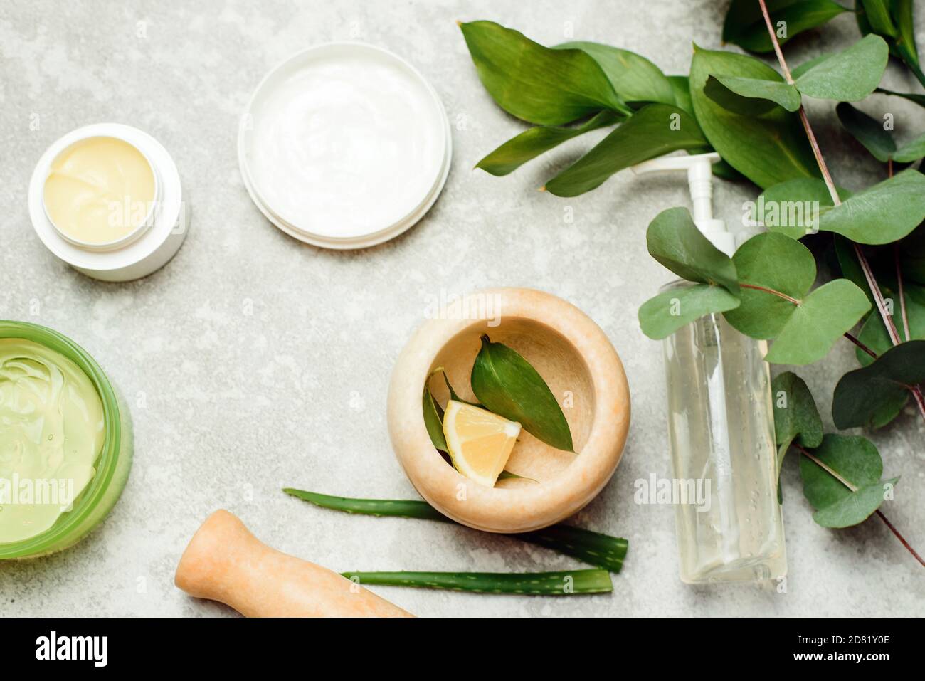 Flat lay composition with cosmetic products on grey background. Gel and ...