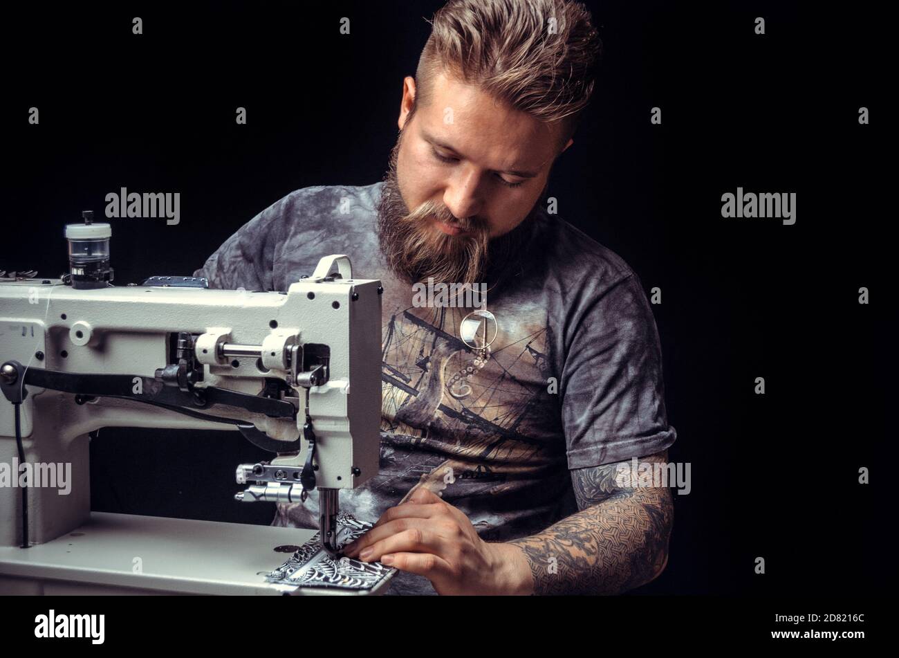 Craftsman working with leather forms new leather product in workshop Stock Photo