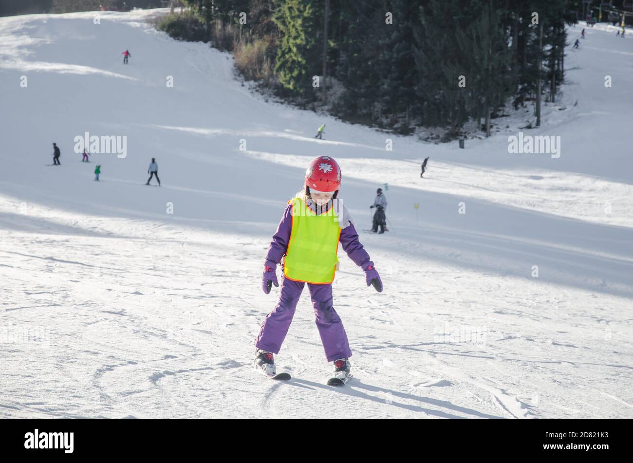 child skier in winter slope having fun with skiing Stock Photo