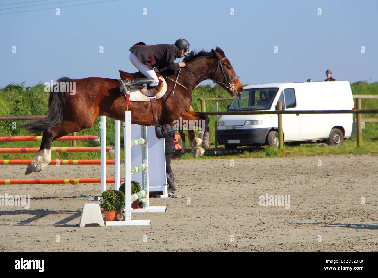PLABENNEC, FRANCE - MARCH 25 : Bay horse jump an obstacle during an equestrian event, March 25, 2017 Stock Photo