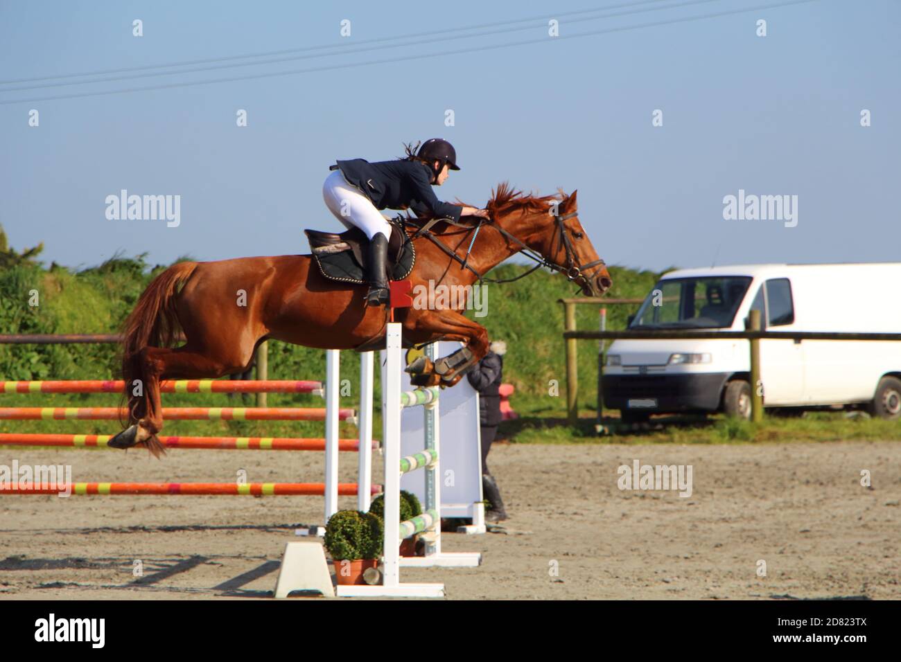 PLABENNEC, FRANCE - MARCH 25 : Woman and chestnut horse jump an obstacle during an equestrian event, March 25, 2017 Stock Photo