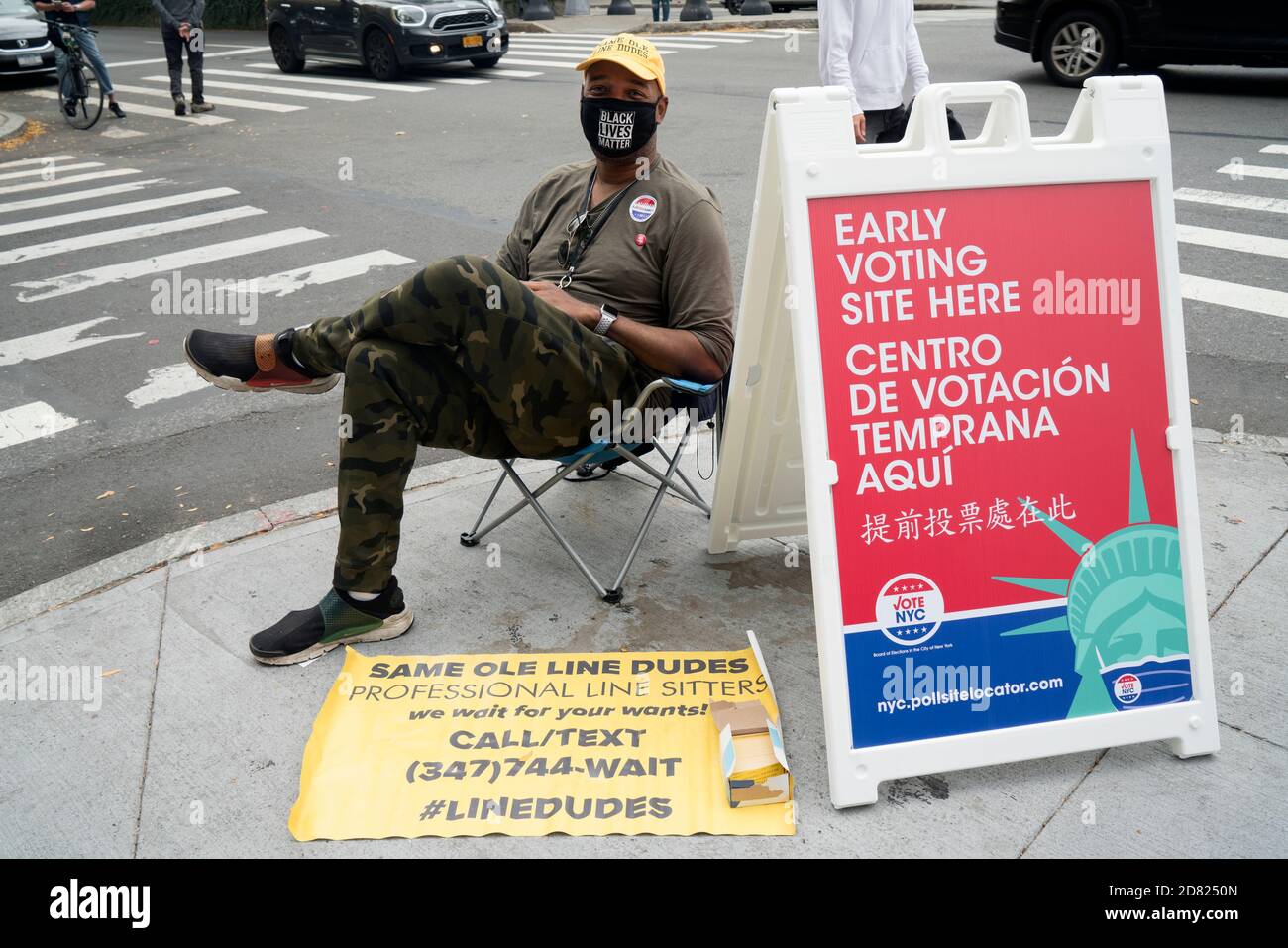 During New York's early voting, Robert Samuel, founder of Same Ole Line Dudes, sat near the line at a poll. People pay him to wait in line for them. Stock Photo