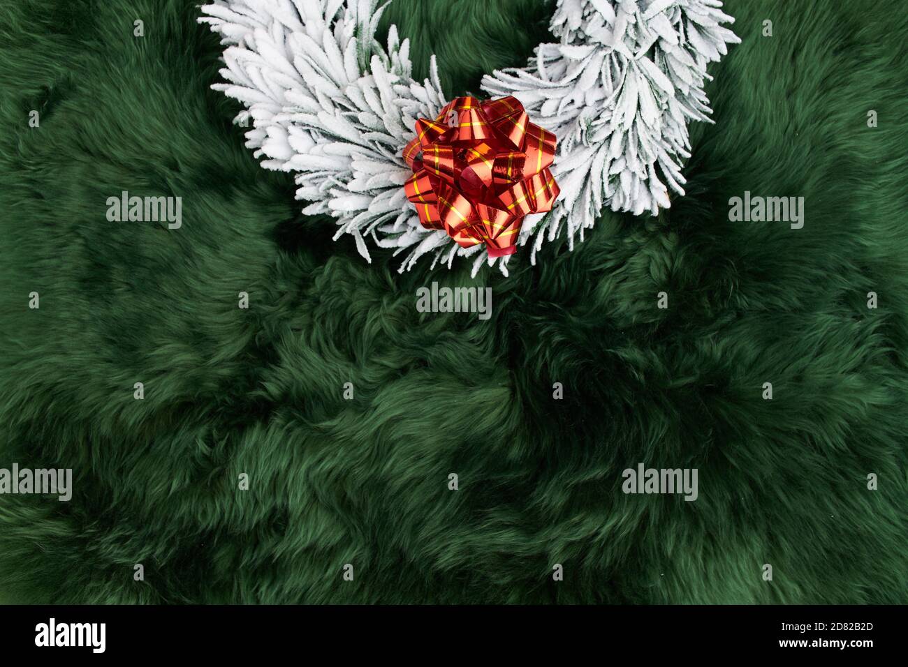Merry Christmas. flat lay with wreath on green rug background. Stock Photo