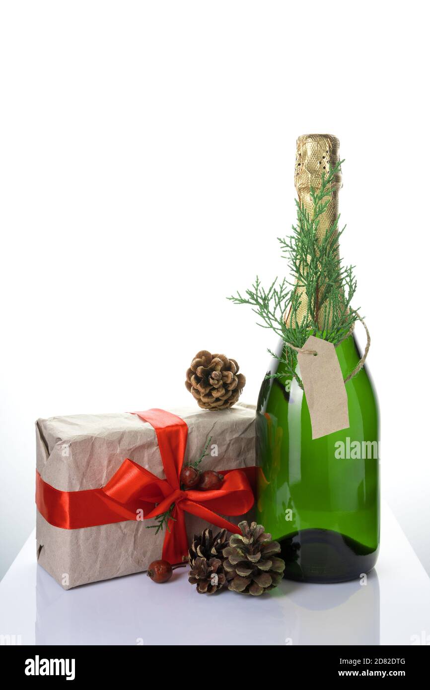 Christmas background with champagne, gift and cones on a light