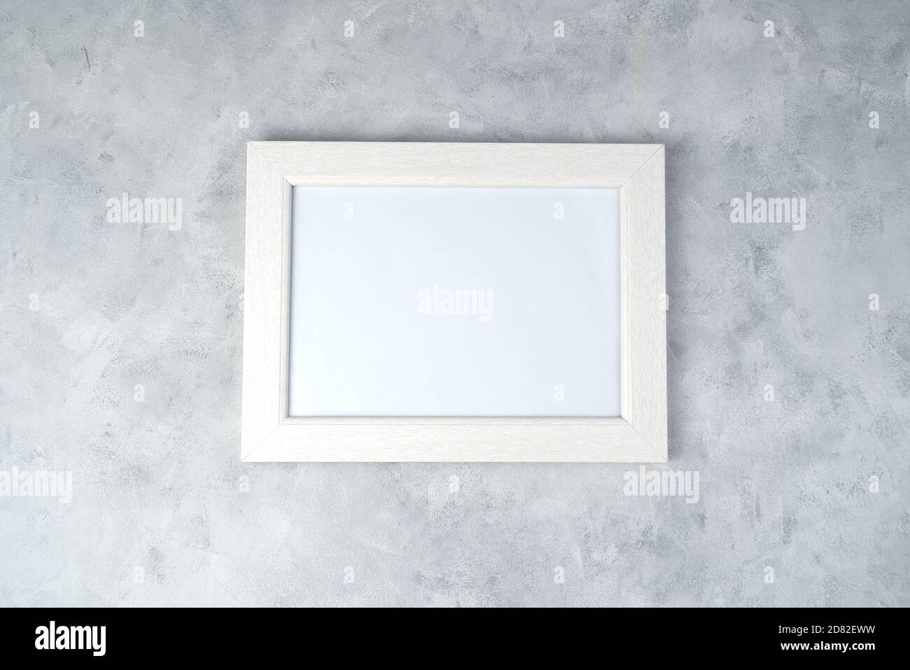 Minimalistic white frame with space for copying, on a concrete background. Stock Photo