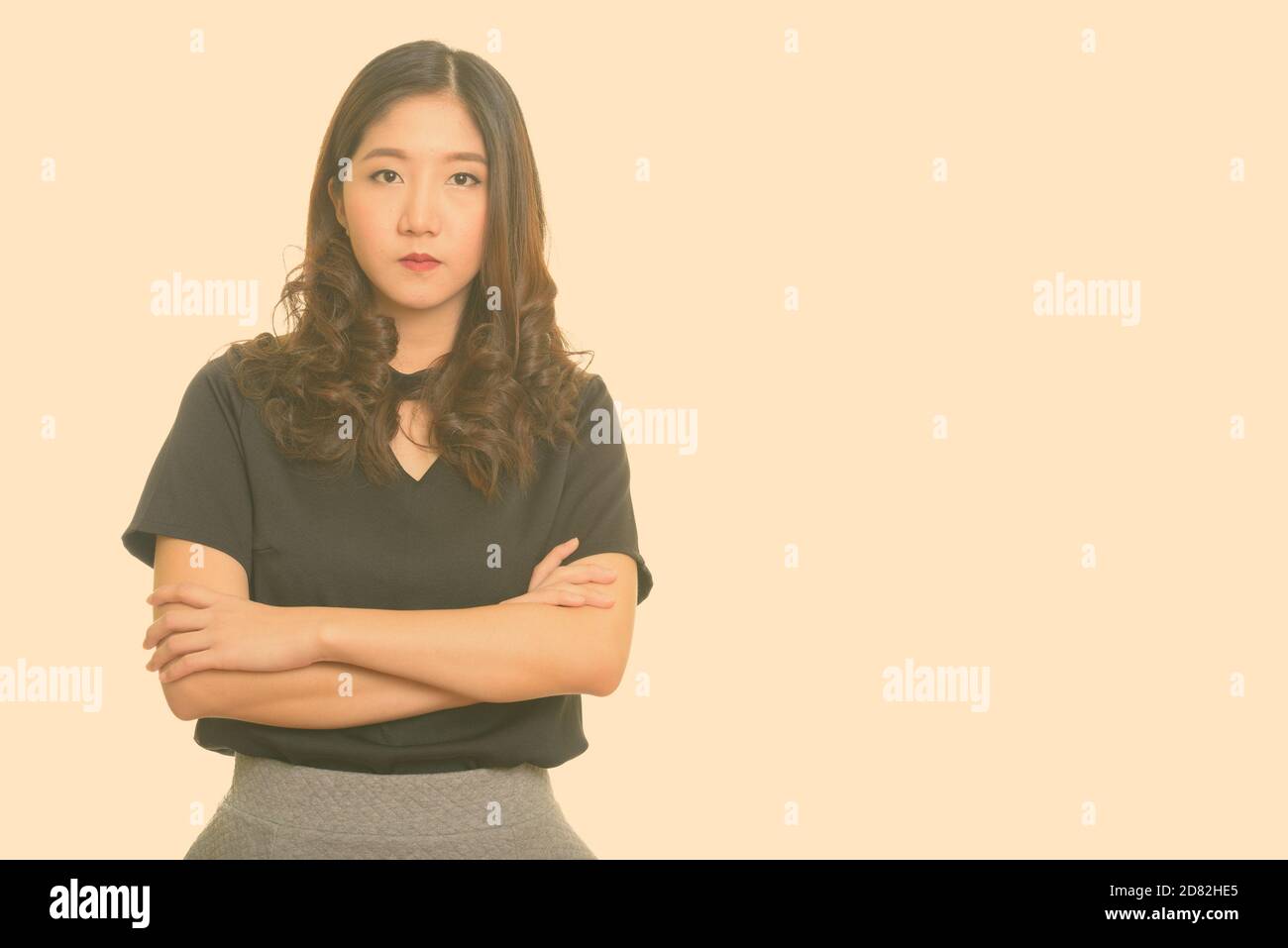 Portrait of young beautiful Asian businesswoman with arms crossed Stock ...