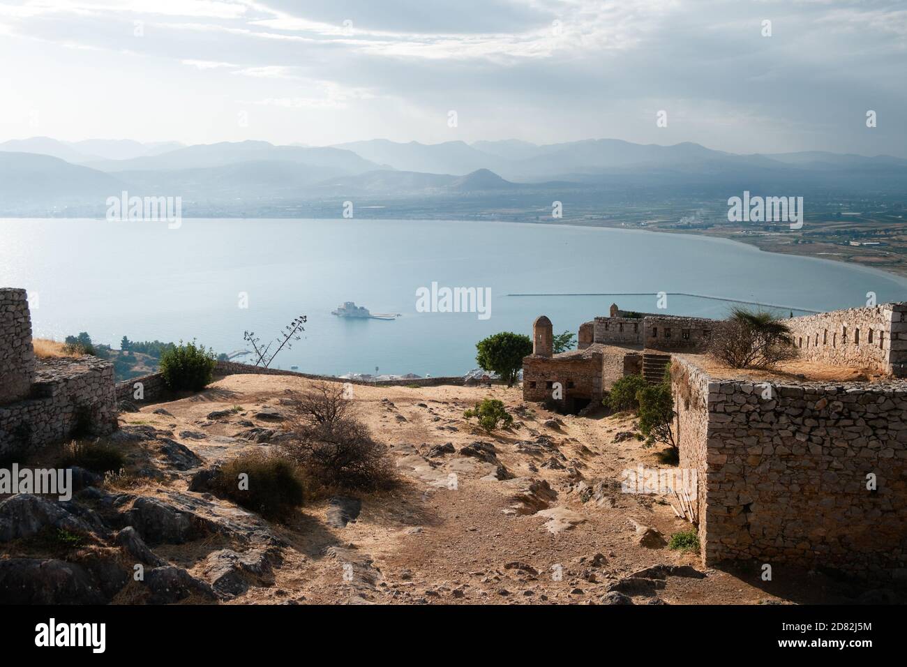 overhead view on ruins of venetian fortress of Palamidi and the bay of Nafplio with castle of Bourtzi on small island at the sunset Stock Photo
