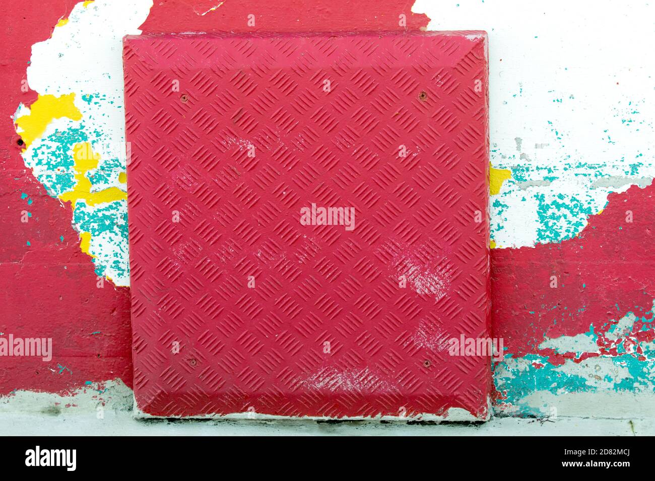 Flakey painted wall and metallic plate Stock Photo