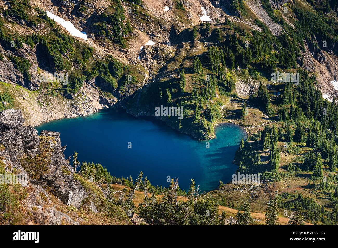 Blue Alpine Lake Surrounded By Green Stock Photo Alamy blue-alpine-lake-surrounded-by-green-stock-photo-alamy