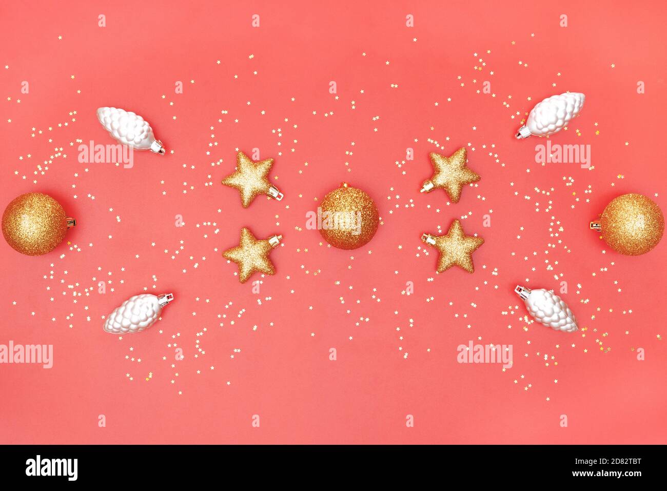 golden ball, star and bell on pink living coral background for birthday, christmas or wedding ceremony Stock Photo