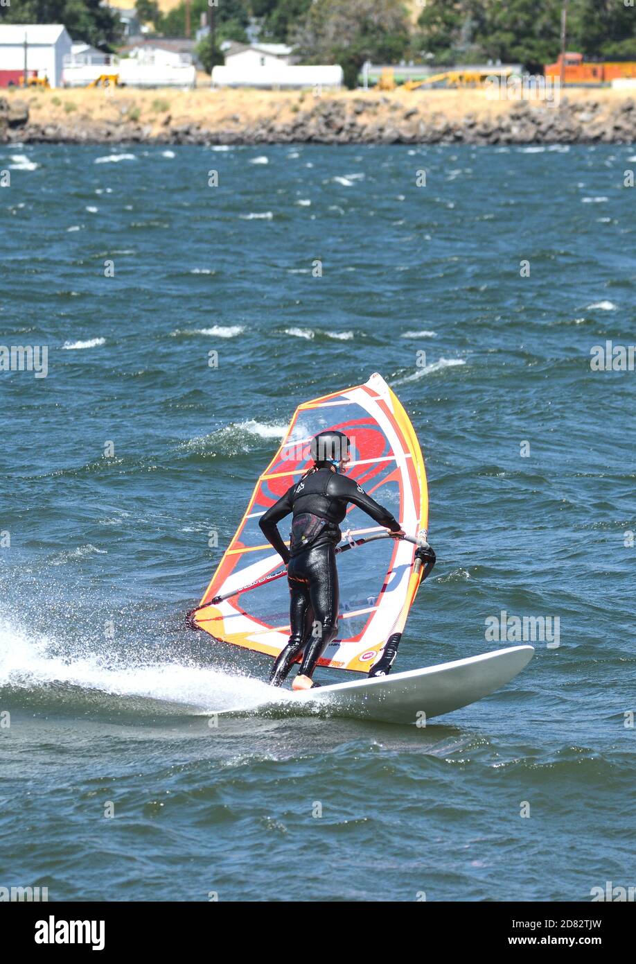 A windsurfer glides through the Columbia River near Hood River, Oregon