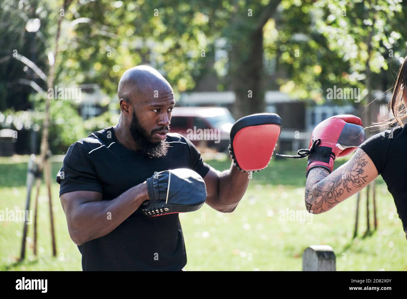 Portrait Of Muscular Male Coach With Boxing Pad Gloves Stock Photo Alamy