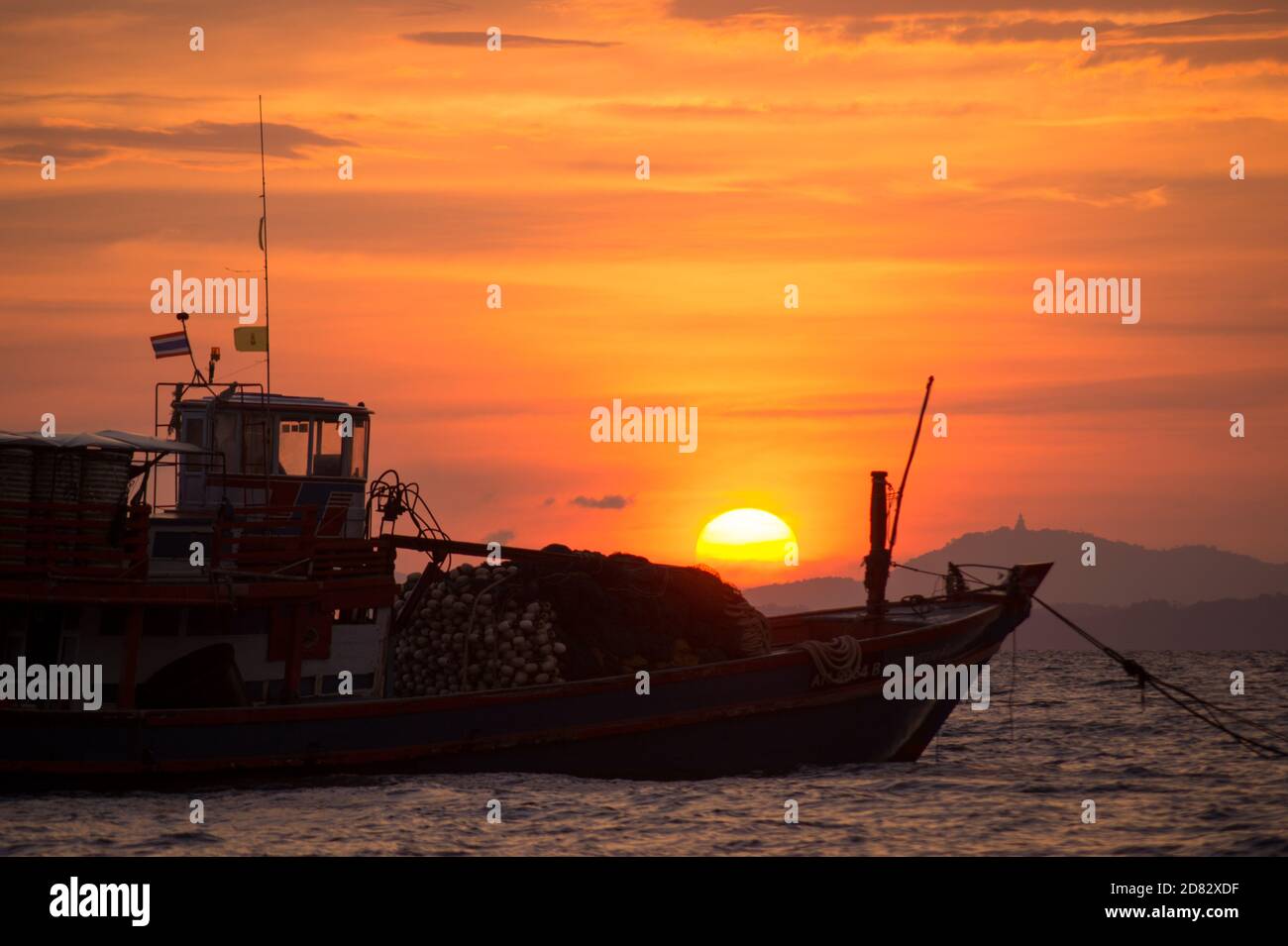 fisher ship during sunset on the sea Stock Photo - Alamy