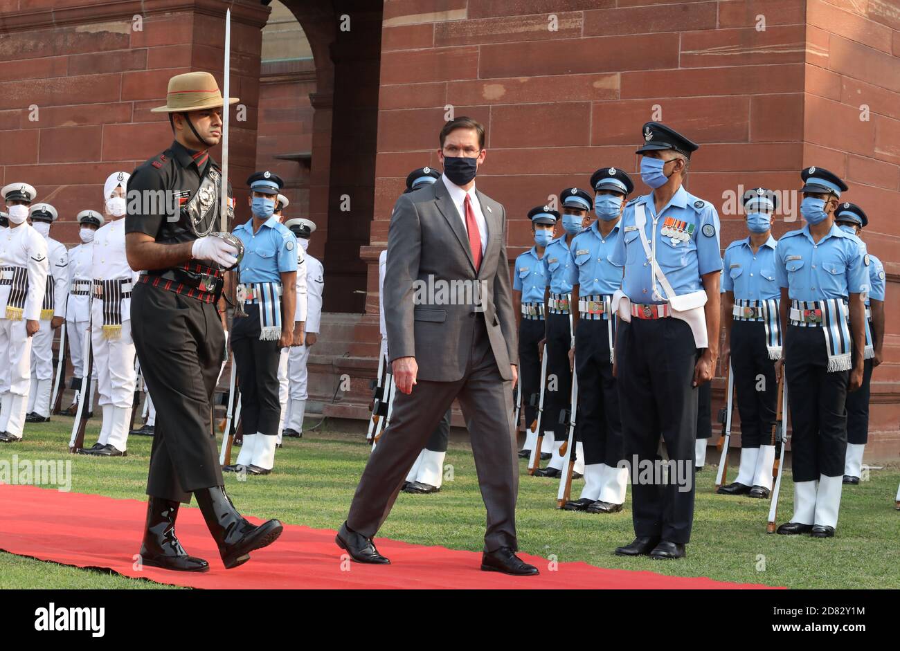 U.S. Defense Secretary Mark Esper wearing a face mask reviews a joint military guard of honour during a ceremonial reception at the Defence Ministry of India.. Stock Photo
