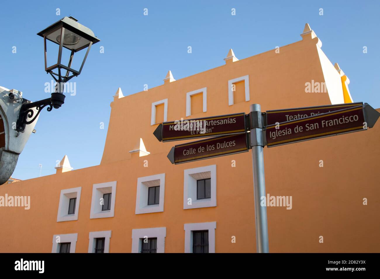 Street lamp and indication sign, in downtown Puebla, under blue sky ...