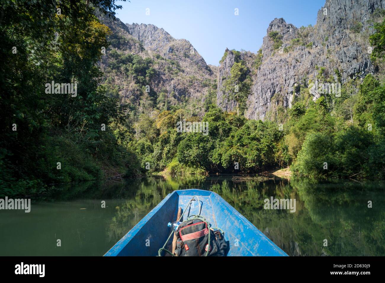 Boat on a river with mountains Stock Photo