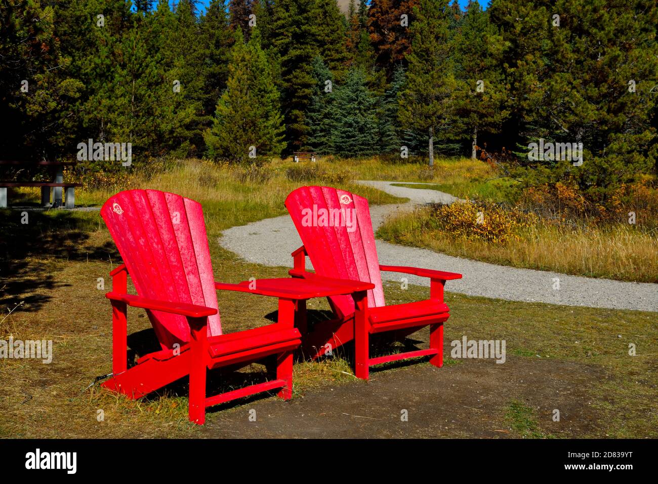 Two red chairs at the end of a hiking path at Maligne Lake in Jasper National Park Alberta Canada Stock Photo