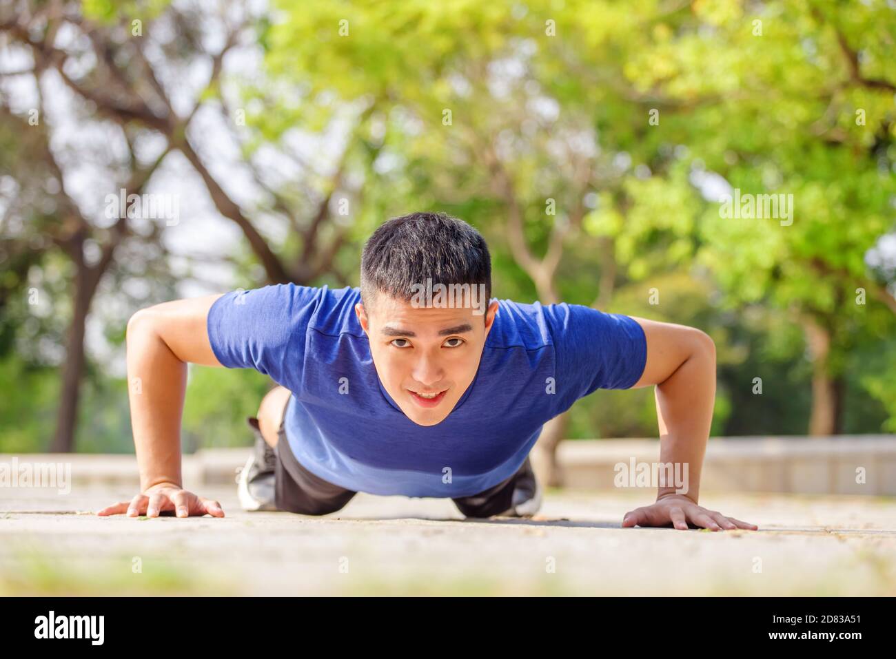 young handsome man doing push up exercise in the park Stock Photo