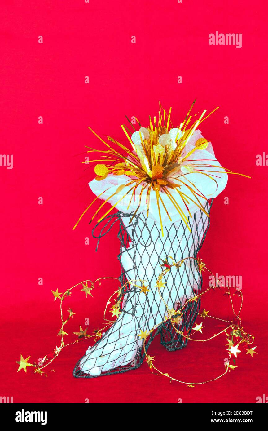 Party trimmings streamers and stars in a tall boot shoe. Overflowing ...