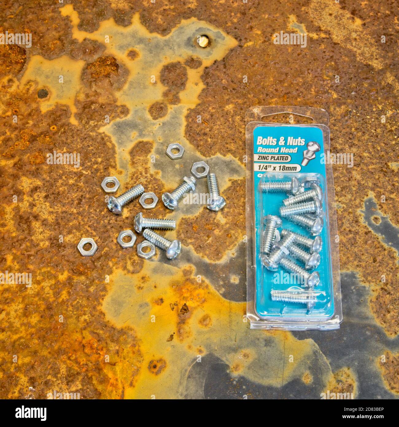 Nuts and bolts package on rusty background surface Stock Photo