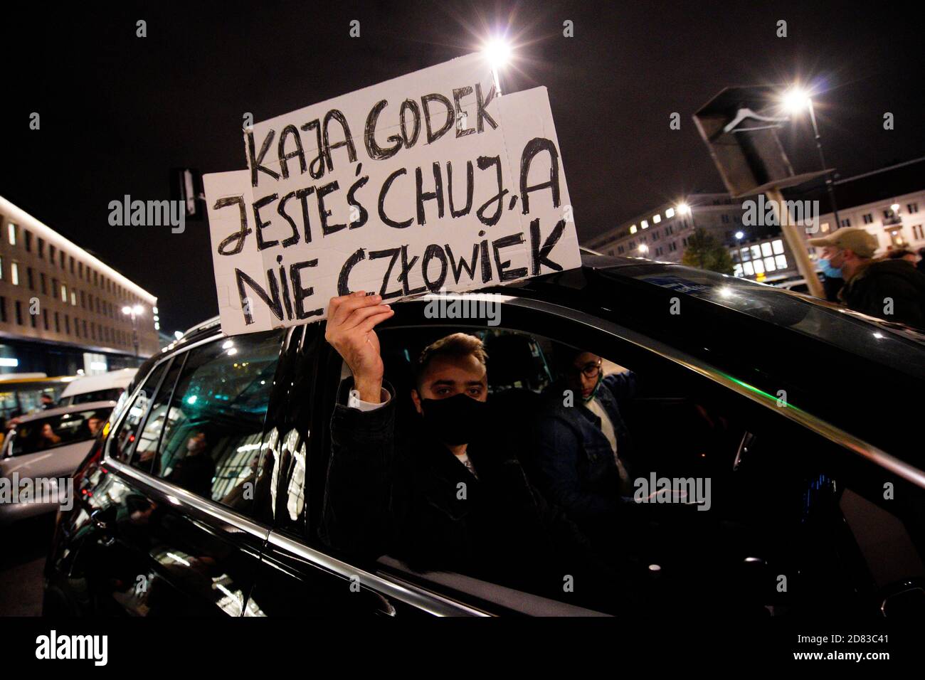 A man holds a sign with insults towards pro-life activist Kaja Godek in  Warsaw, Poland on October 26, 2020. On Monday for the fifth day in a row  pro-c Stock Photo -