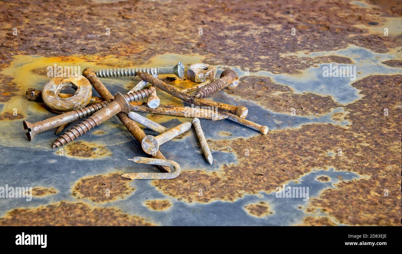 Small pile of rusty nails nuts and bolts Stock Photo