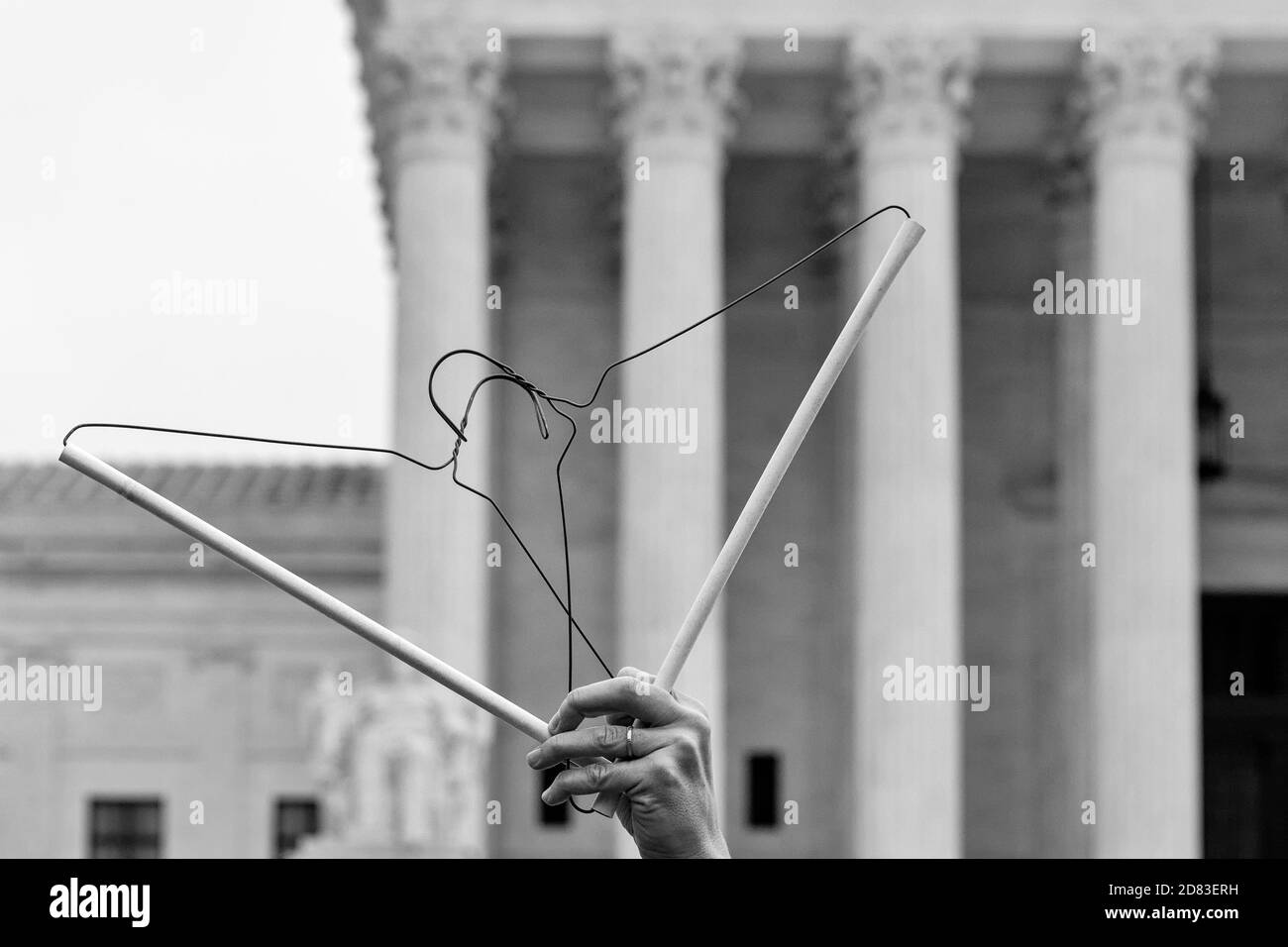 Washington, DC, USA, 26 October,  2020.  Pictured: A woman stood at the Supreme Court for the better part of an hour holding coathangers against the backdrop of the Supreme Court while protesting against the confirmation of Amy Coney Barrett and in favor of reproductive, civil, and women's rights.  This was part of Refuse Fascism's  protest just hours before Barrett was confirmed by the U.S. Senate.  Credit: Allison C Bailey/Alamy Live News Stock Photo