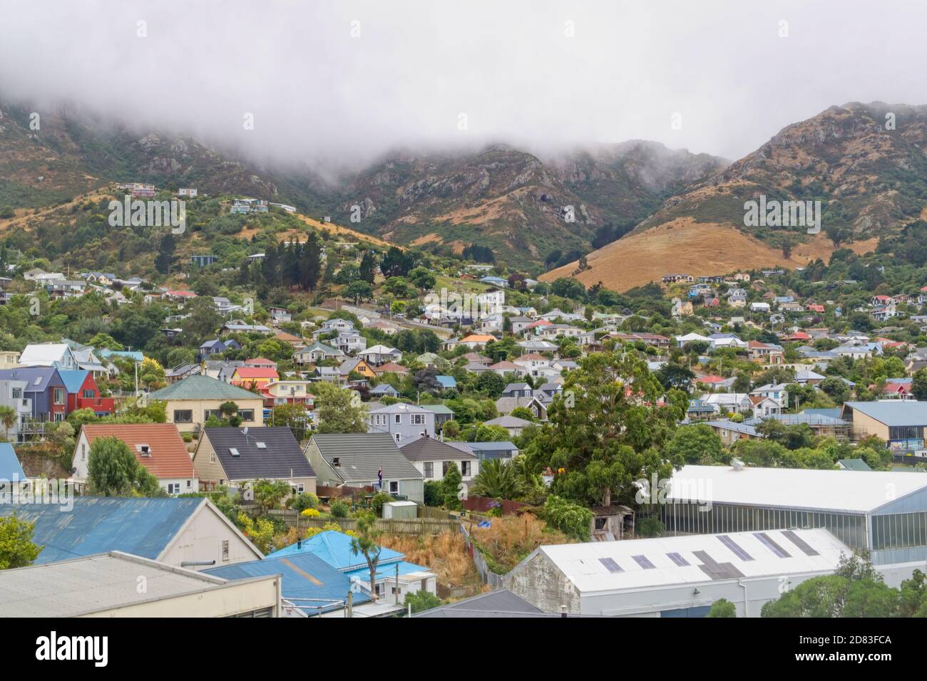 The cloud covered hills around the town of Lyttelton NZ Stock Photo