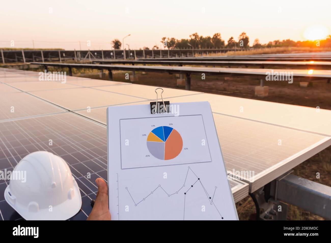 Engineers are examining the performance graph of energy production from ...