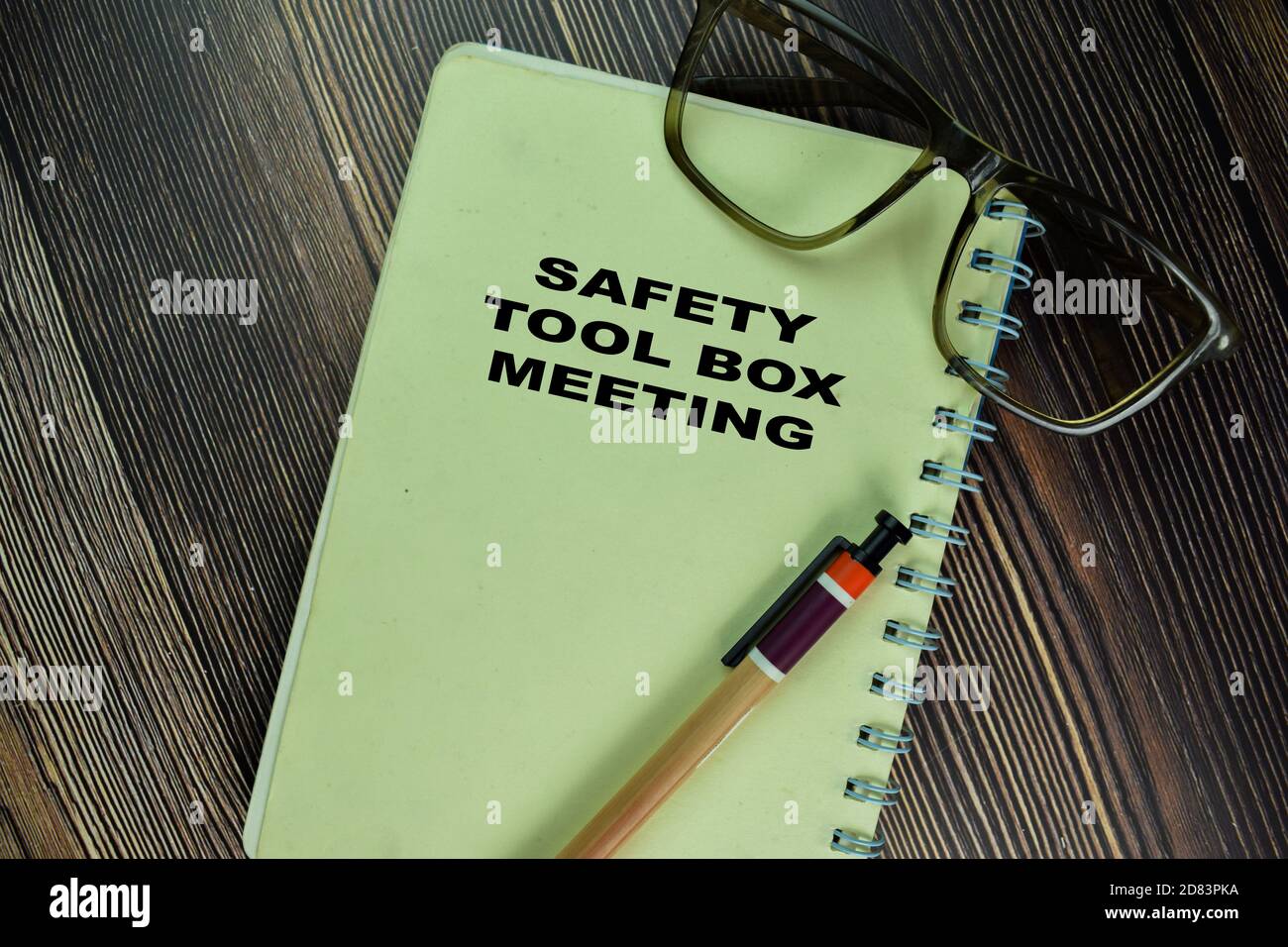 The Book of Safety Tool Box Meeting isolated on wooden table Stock