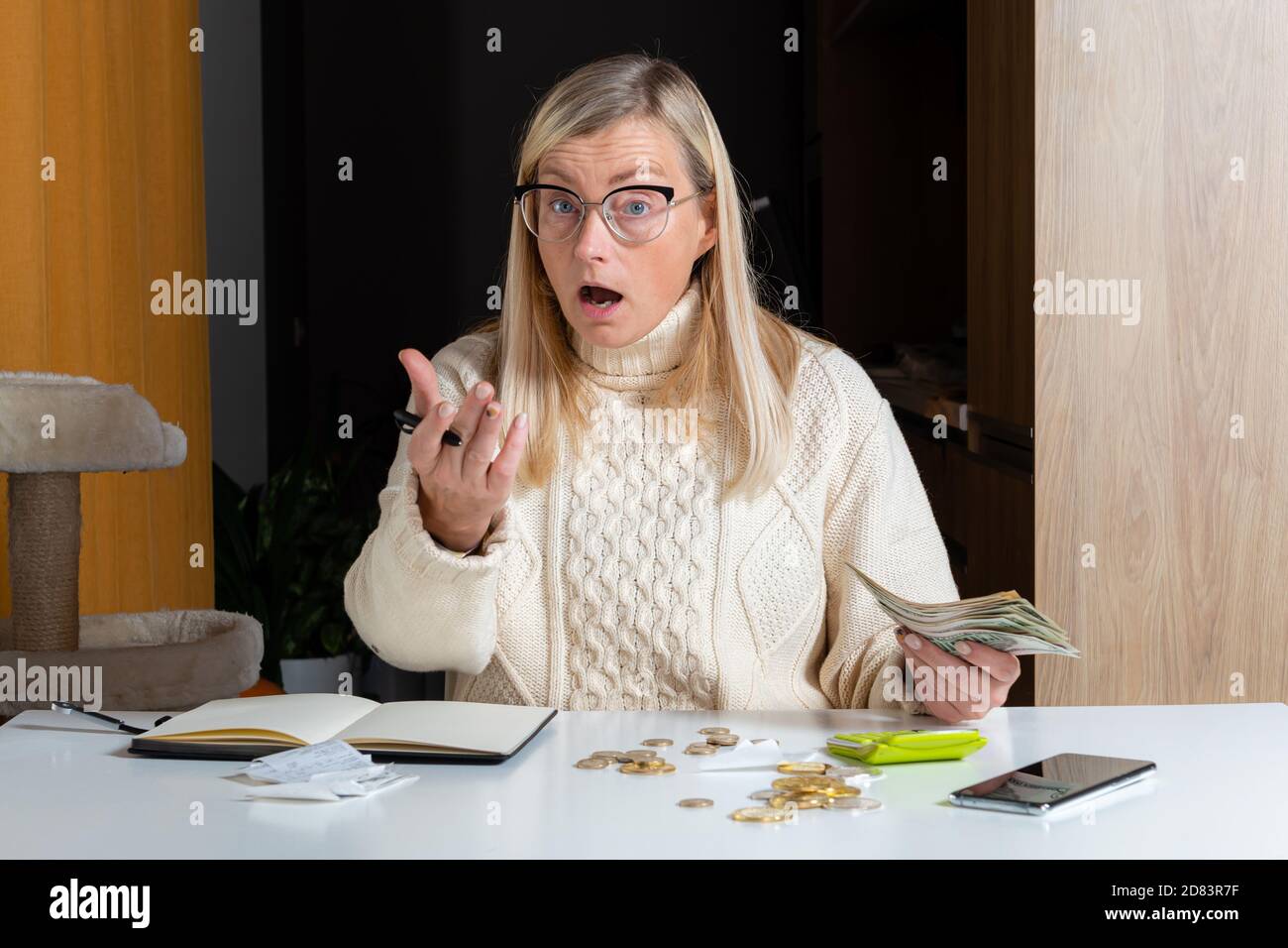 emotional freelance woman calculating budget in home office, expense