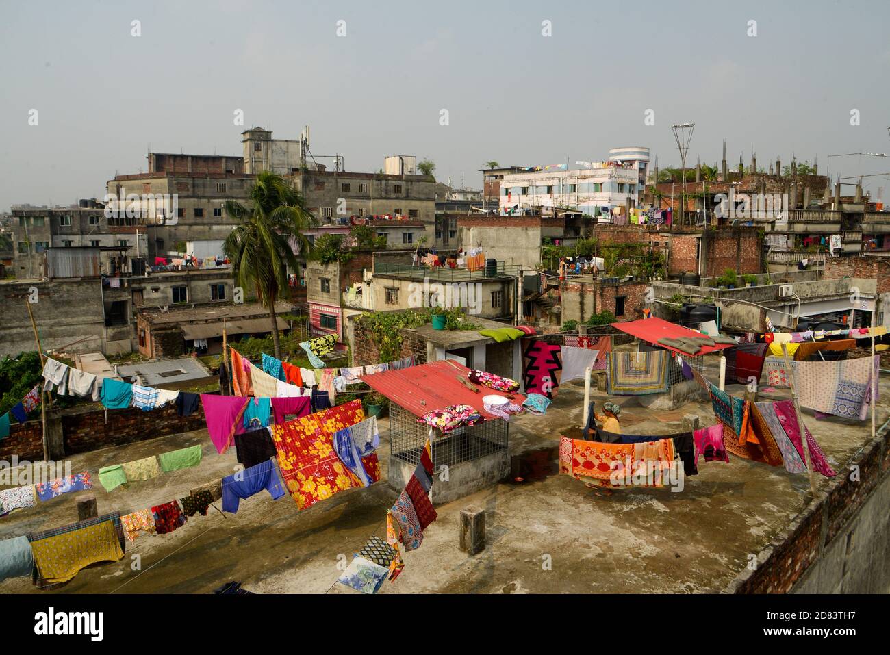 Dhaka, Bangladesh. 27th Oct, 2020. A woman seen hanging clothes to dry at the Hazaribagh tannery industry area.Most people in this area have become victims of pollution due to the presence of toxic chemicals, mainly chromium. The air of Hazaribagh is polluted with the smoke from the waste from the tannery industry. Credit: SOPA Images Limited/Alamy Live News Stock Photo