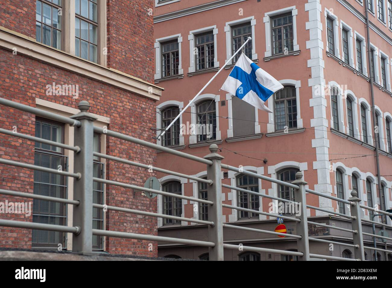 24.06.2018, Helsinki, Finland, Europe - A Finnish flag waves in front of a building in the centre of the capital city. Stock Photo