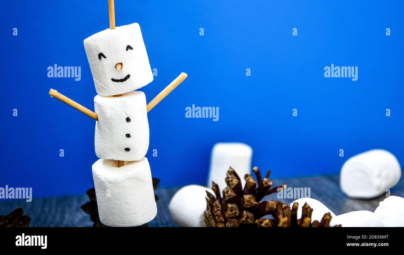 DIY white marshmallows sweet treat for kids funny marshmallow christmas snowman. Step by step. Copy space Stock Photo