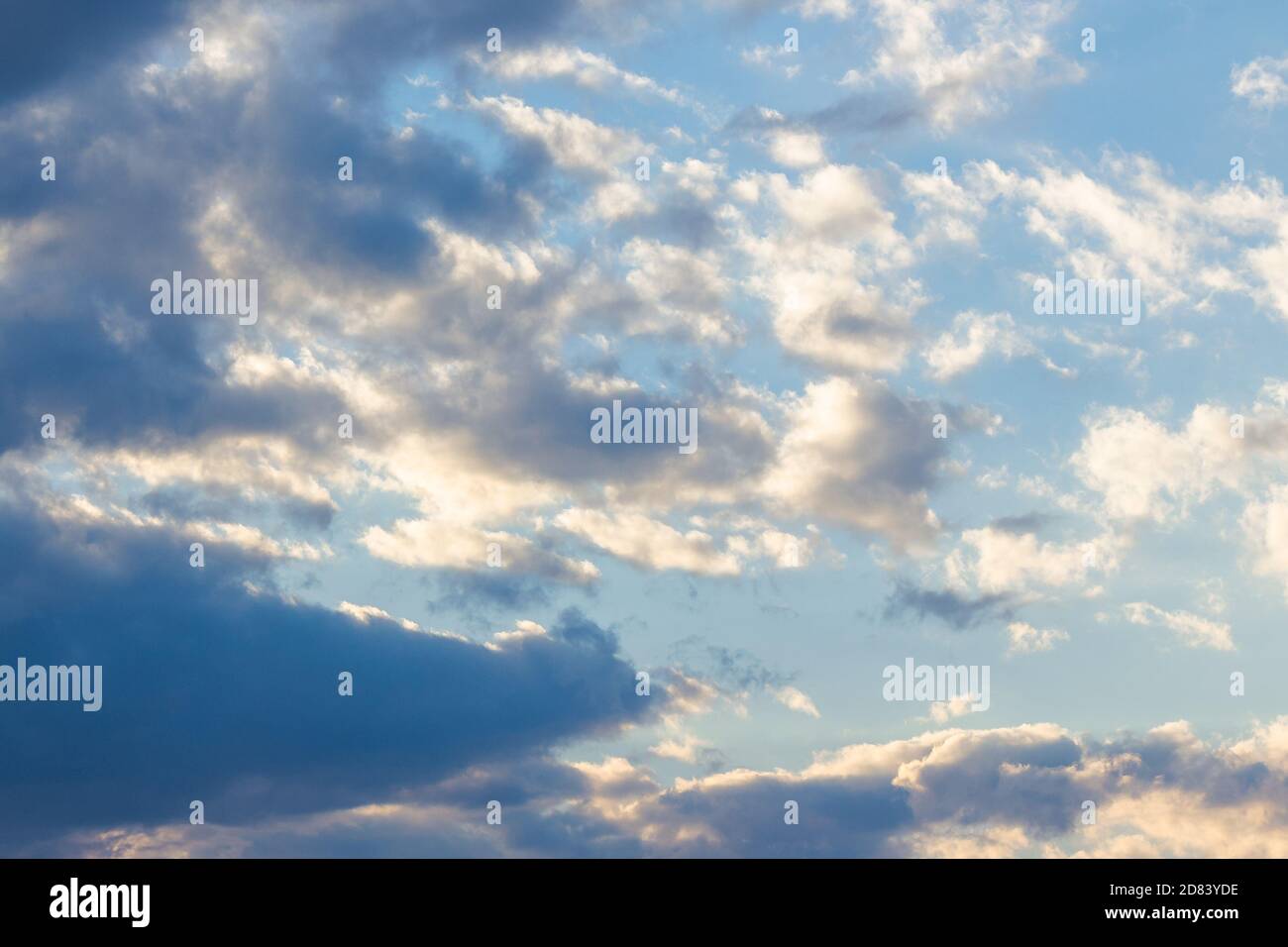 cloudy sky in yellow light. natural background at sunrise. inspiring scene Stock Photo