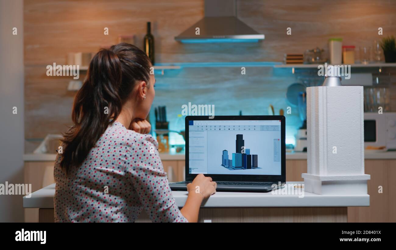 Designer using cad software to design a 3D concept of buildings working ...