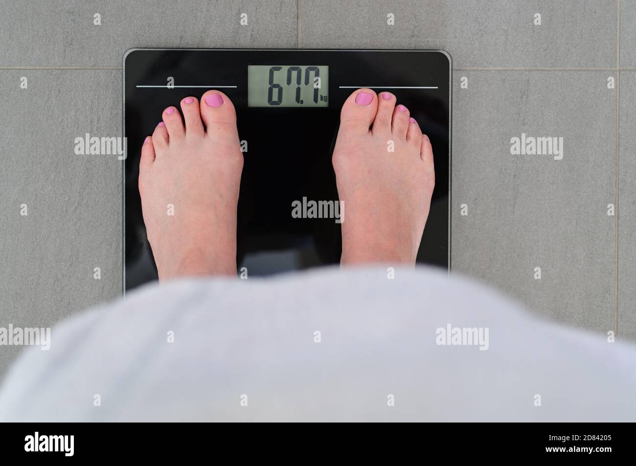 Girl Weighing Herself Scale High Resolution Stock Photography And Images Alamy