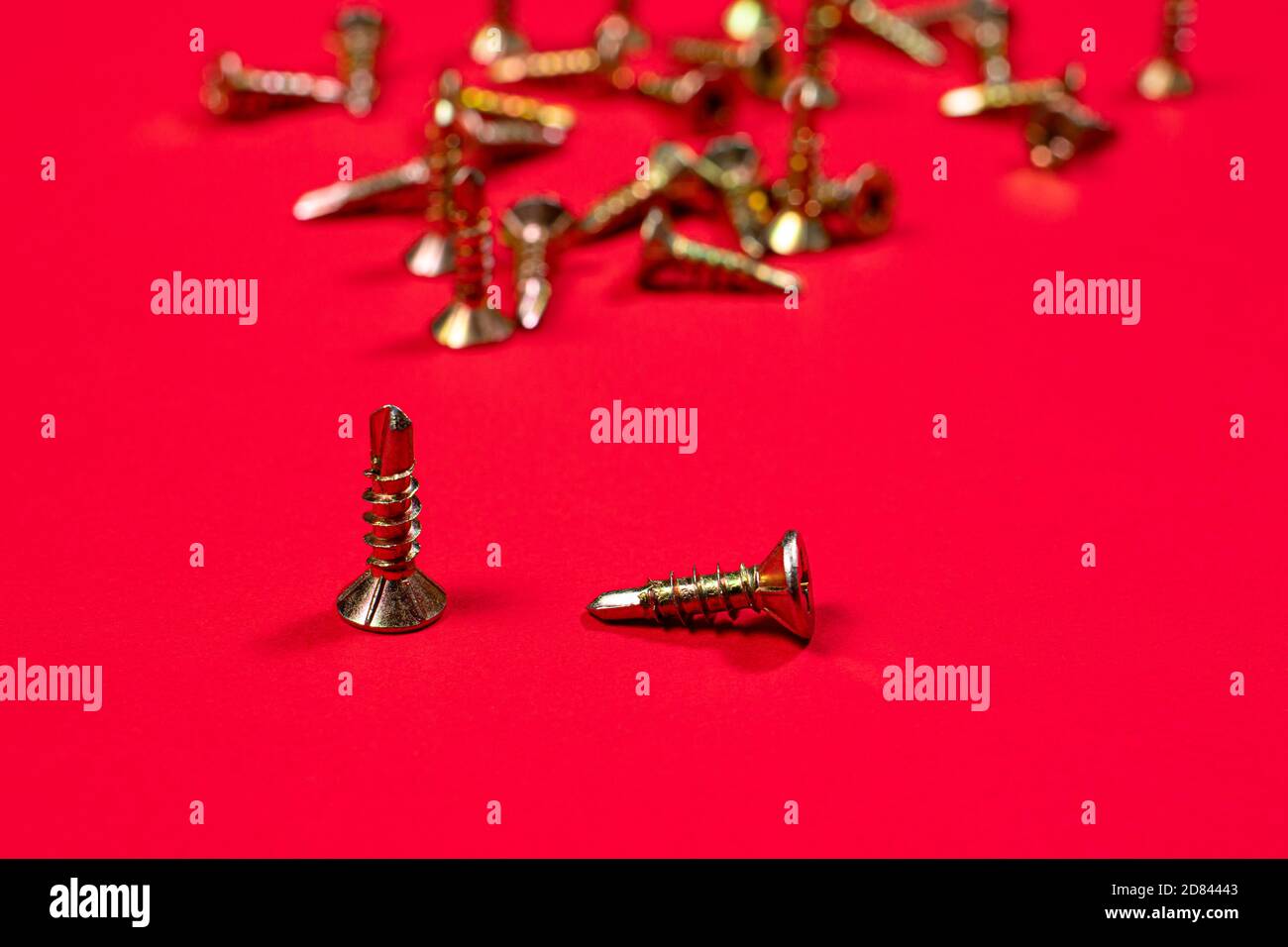Self-cutters on a bright red background. Furniture and parts for repair and construction Stock Photo