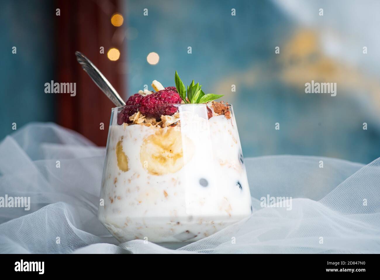 Berry fruit parfait with pudding and cream topped with fruits in a glass cup closeup Stock Photo