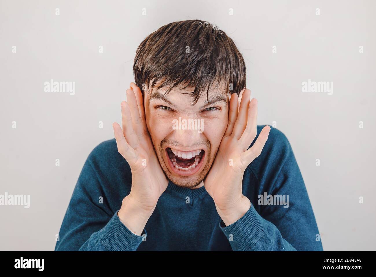 close up. casual emotional young man screams. Stock Photo