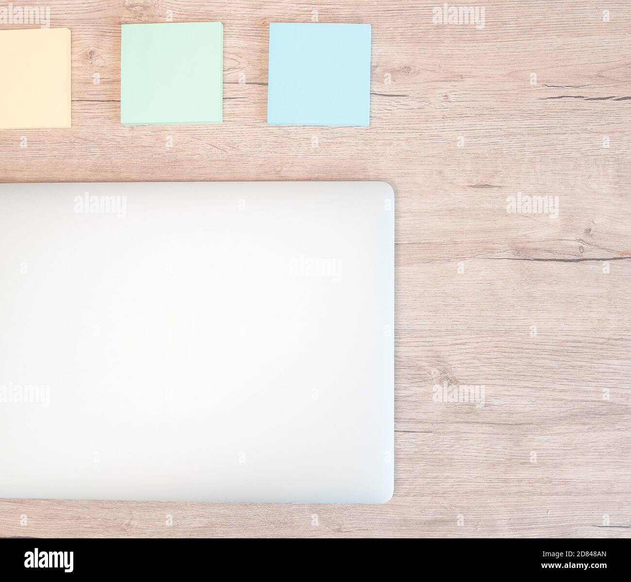 close up. sticky notes and a white laptop on the table. Stock Photo