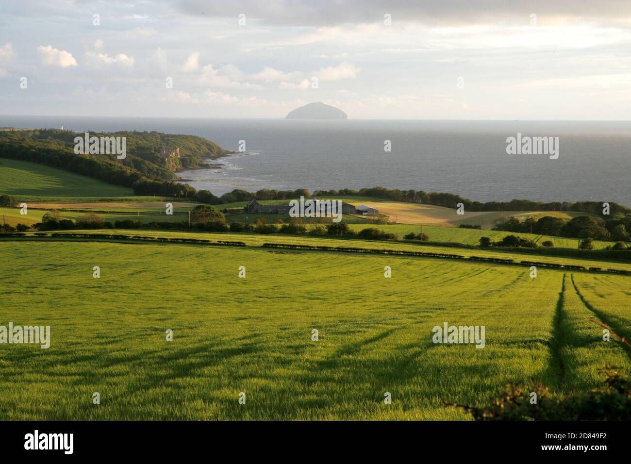 Croy, Ayrshire, Scotland, UK. The Ayrshire coast looking west toward Ailsa Craig with the iconic Ailsa Craig ad Culzean Castle . Stock Photo