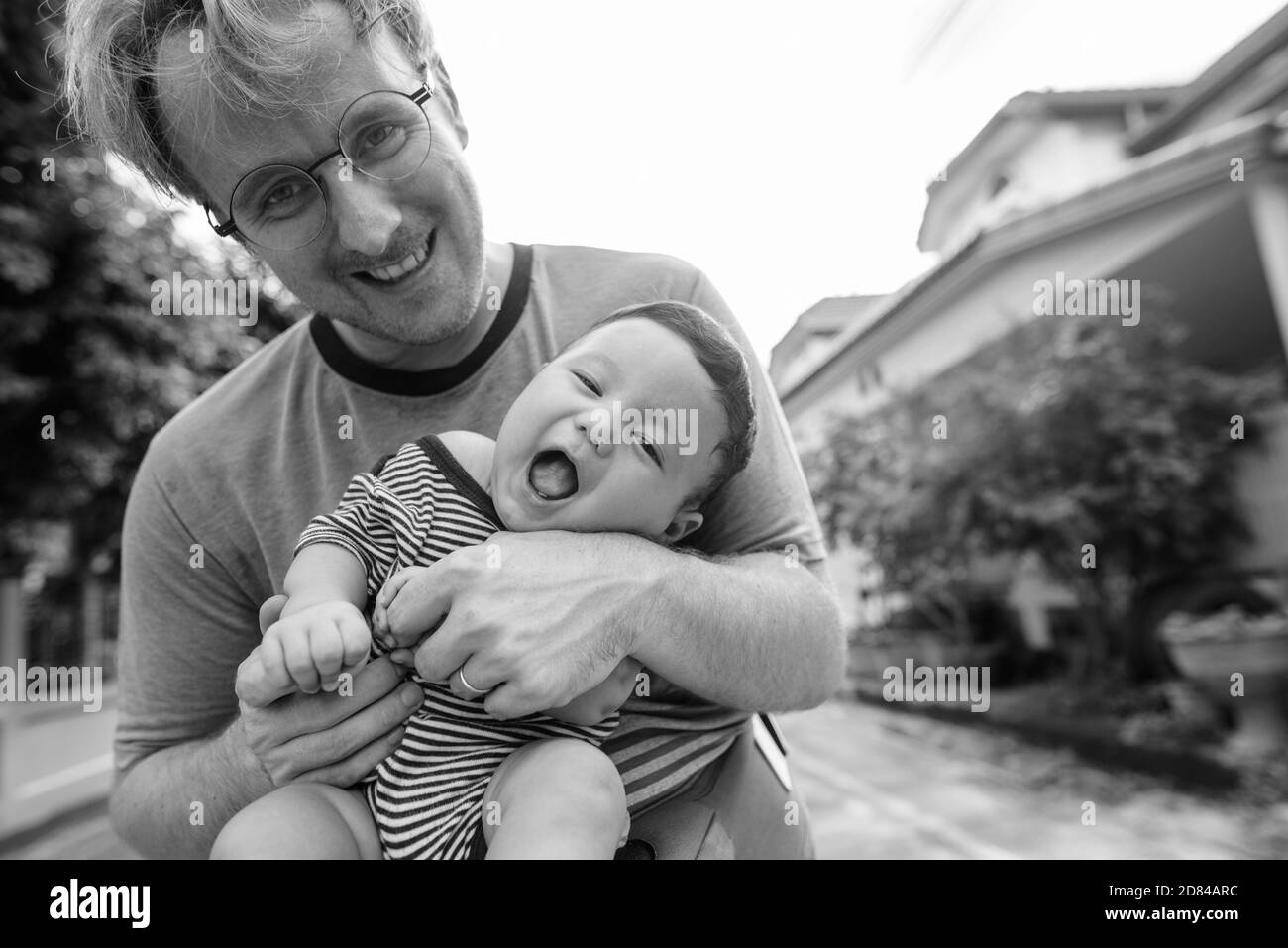 Father and baby son bonding together at home outdoors Stock Photo