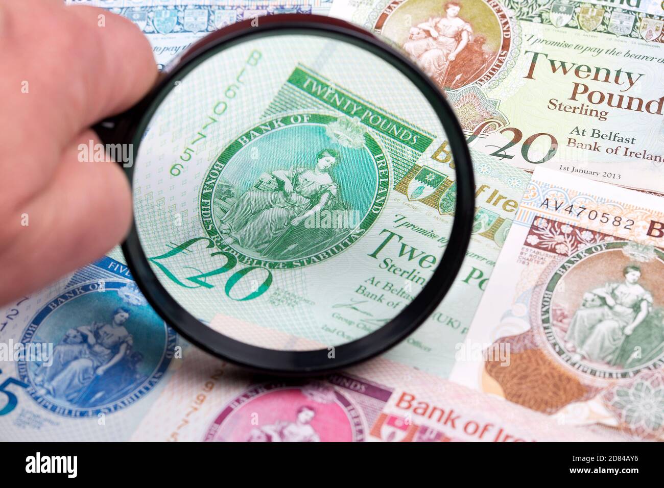Northern Irish pounds in a magnifying glass Stock Photo