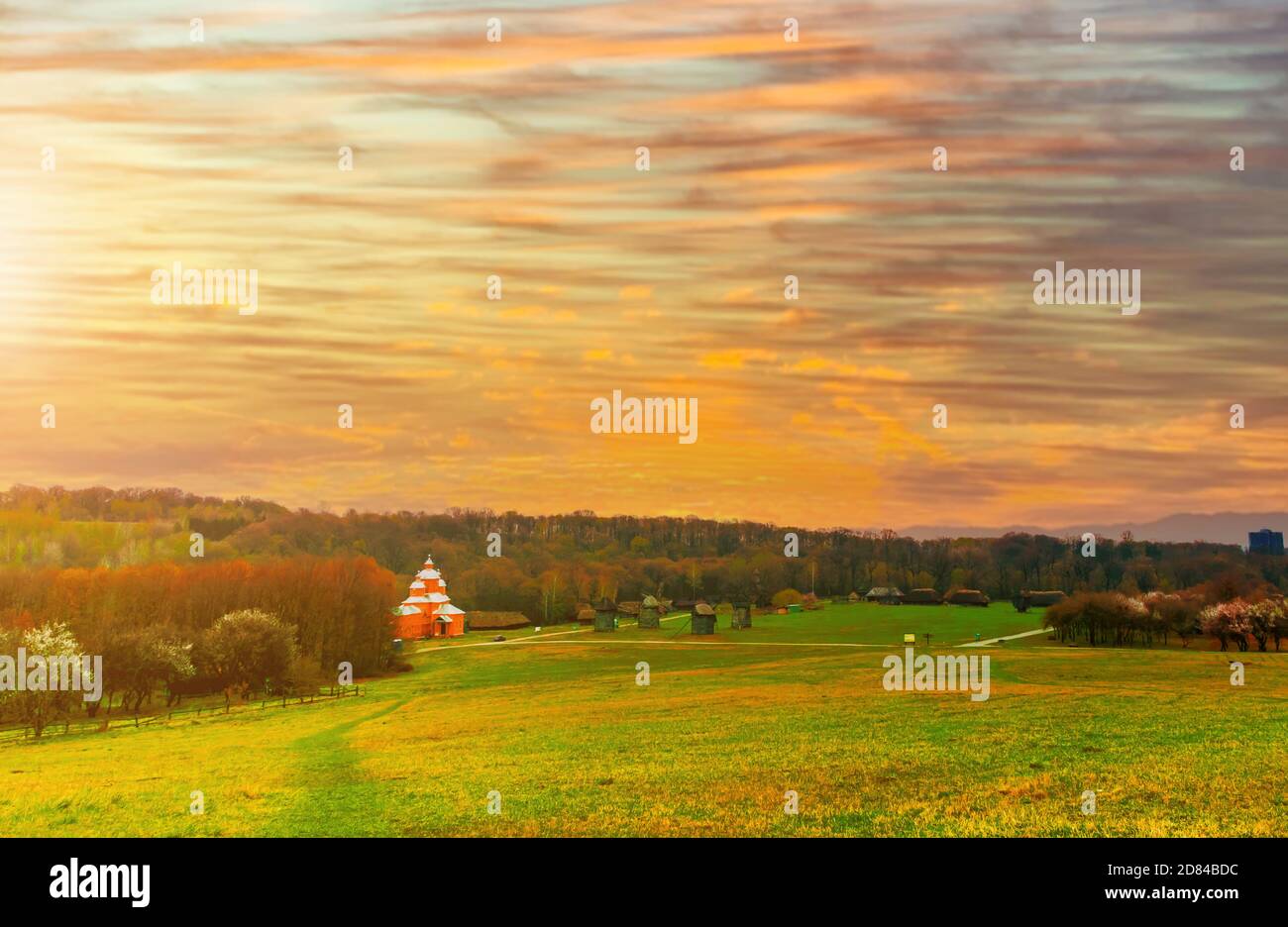an orthodox church in a yellow field in a rural countryside area of Ukraine at sunset Stock Photo