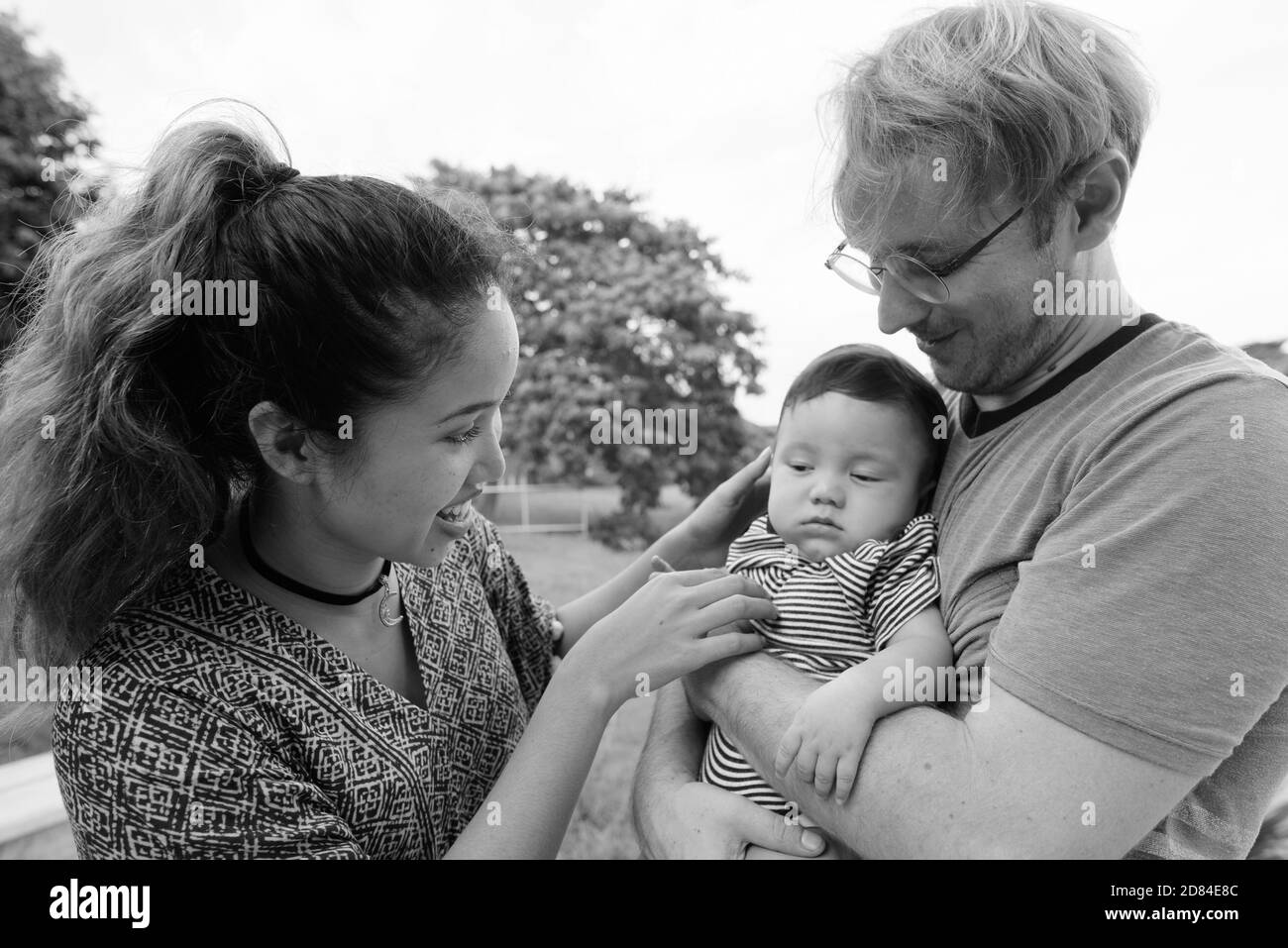 Multi ethnic young family bonding together at the park Stock Photo