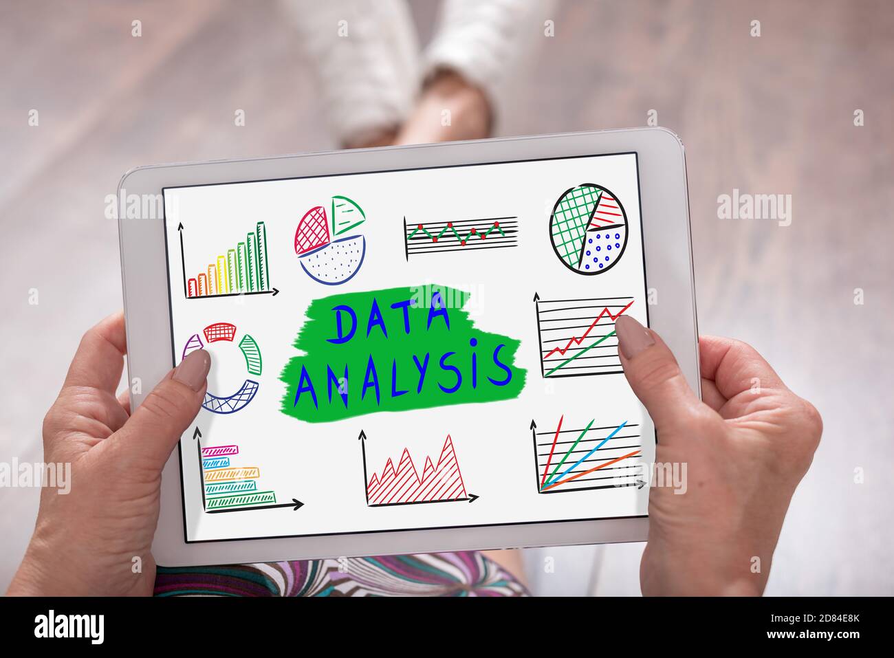 Data analysis concept shown on a tablet held by a woman Stock Photo