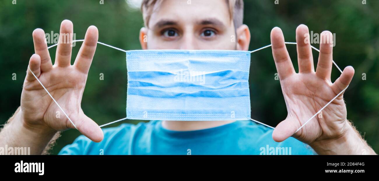 Man holding mask face hi-res stock photography and images - Alamy