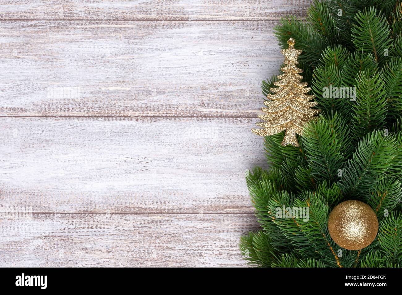 Mock up gold ornaments on the branches of Christmas tree, Christmas card Stock Photo