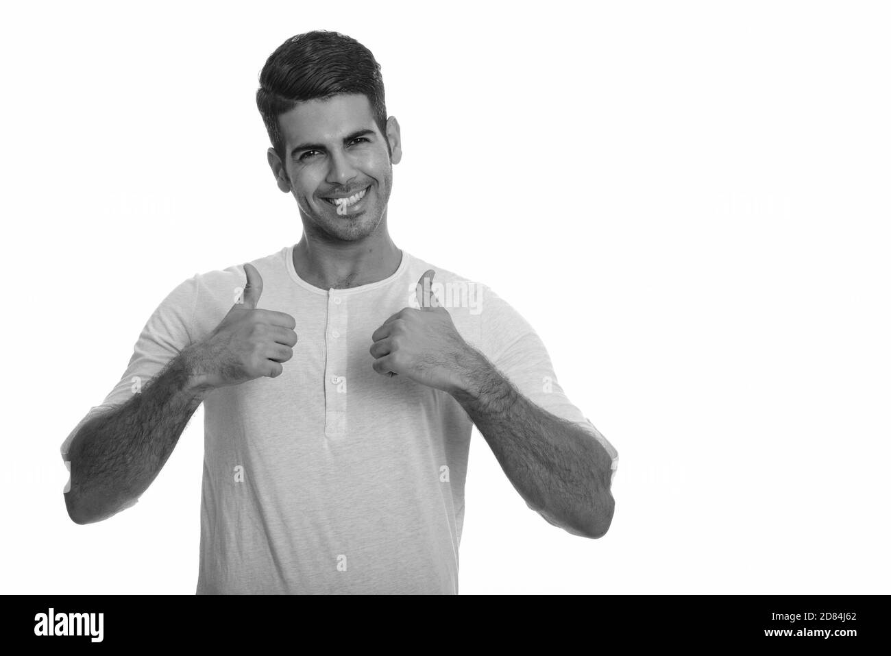 Young happy Persian man smiling giving thumbs up Stock Photo - Alamy